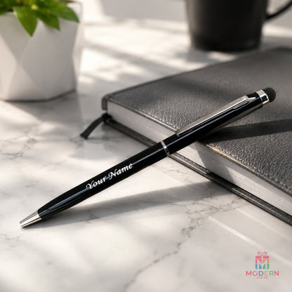 Personalized black touch pen with silver accents placed on a notebook