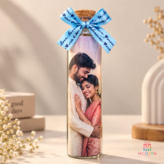 Personalized photo message bottle featuring a couple's photo inside a glass bottle with a decorative blue ribbon