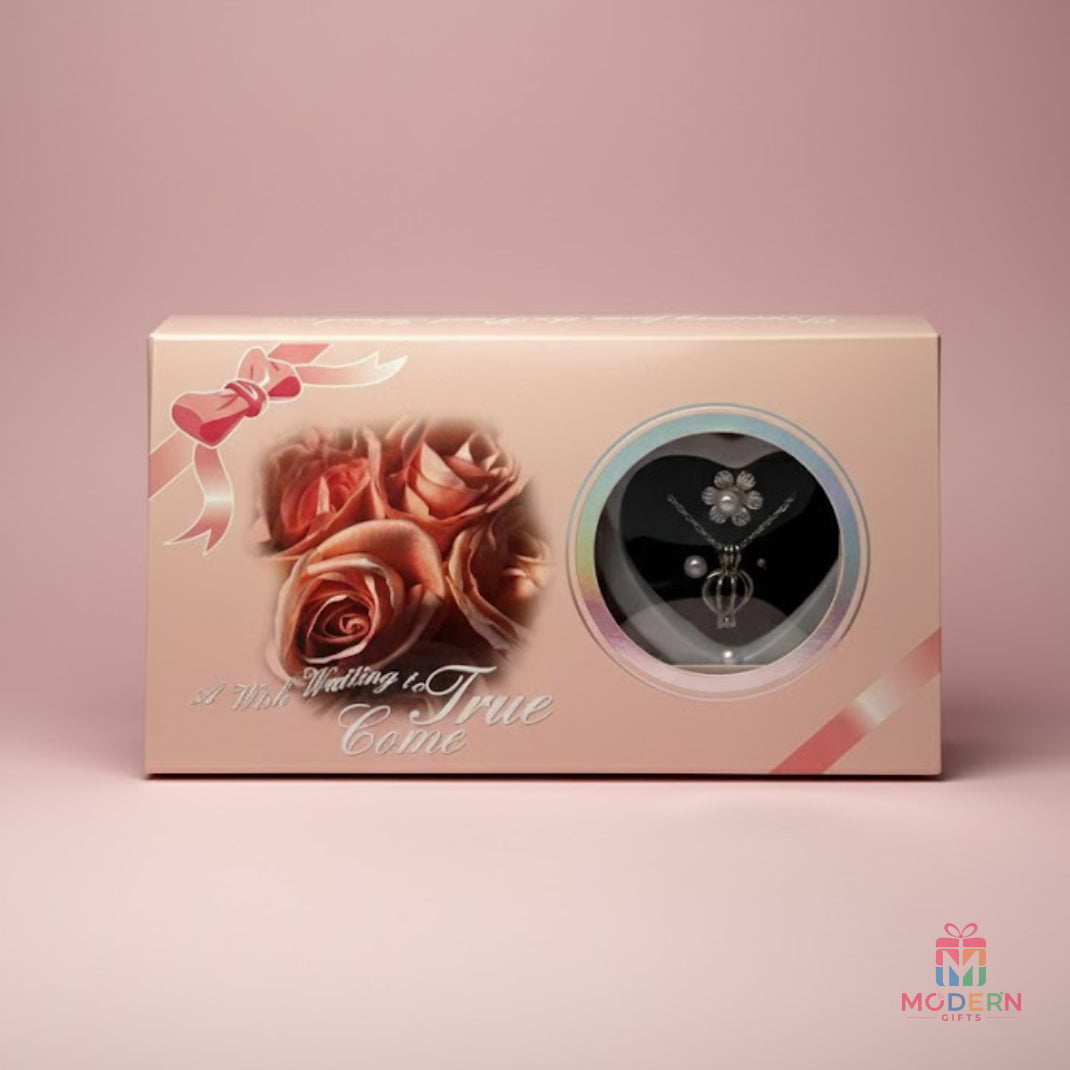 Elegant pearl pendant and matching earrings displayed in a heart-shaped jewellery gift box