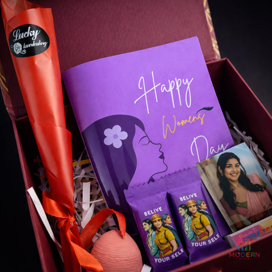Women's Day gift hamper with flower bouquet, personalized greeting card, chocolates, and photo gift in a premium gift box.