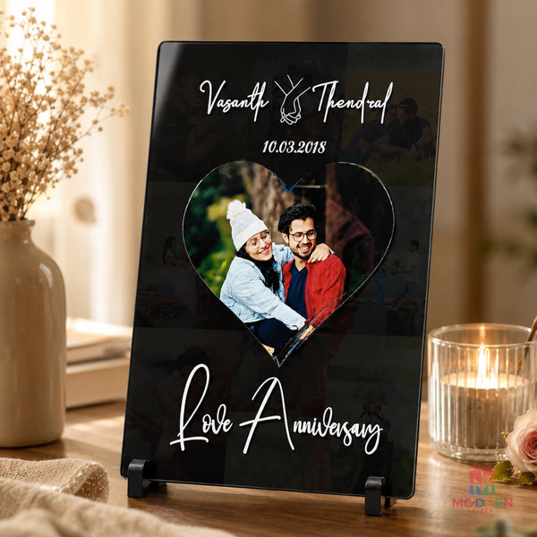 Personalized love anniversary acrylic photo frame with couple photo, custom names and anniversary date, displayed on a tabletop stand