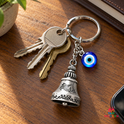 Blue Evil Eye Bell Keychain with engraved silver bell charm and metallic key ring, stylish protective charm accessory from Modern Gifts.